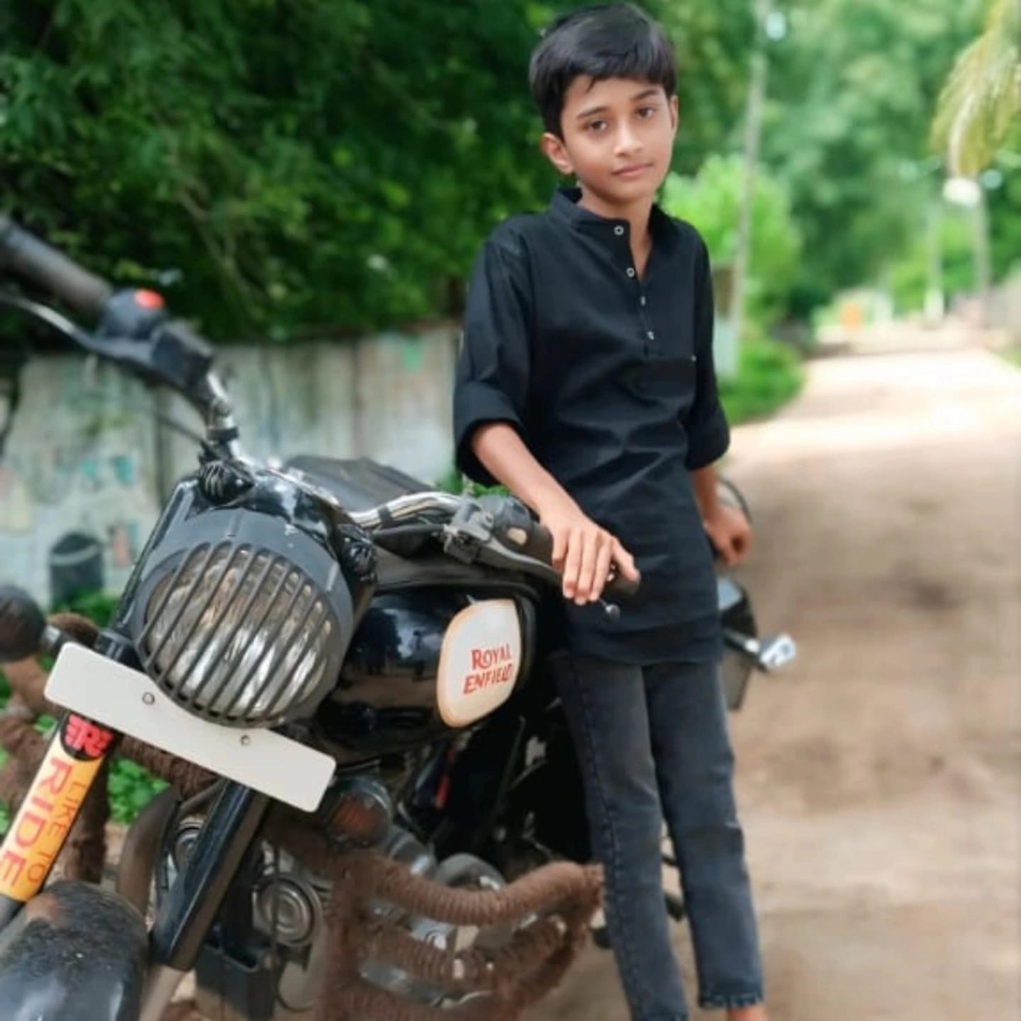 Sanjay smiling with a small robot project